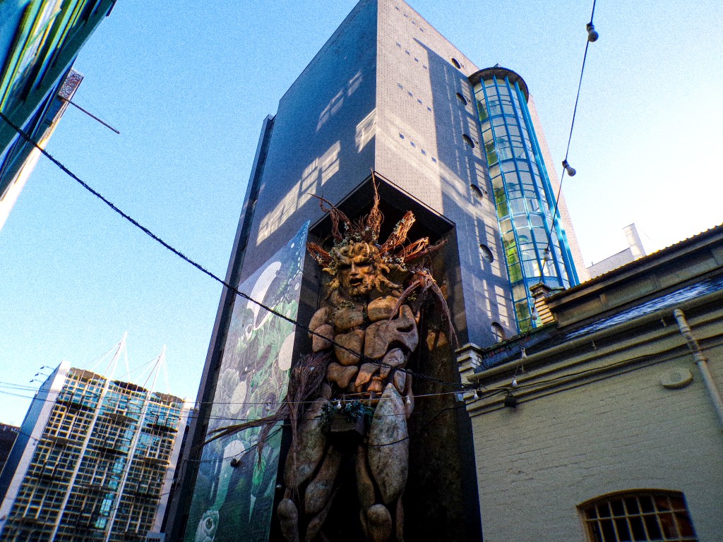an art sculpture of a man made of trees
