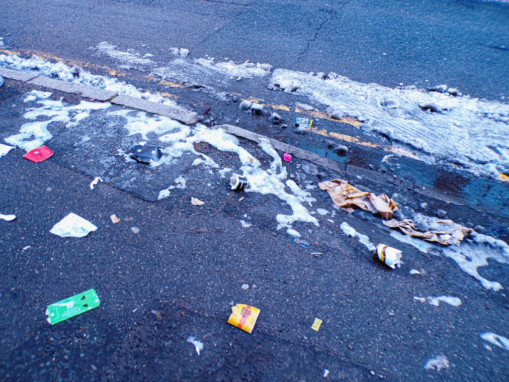 litter and snow on the street